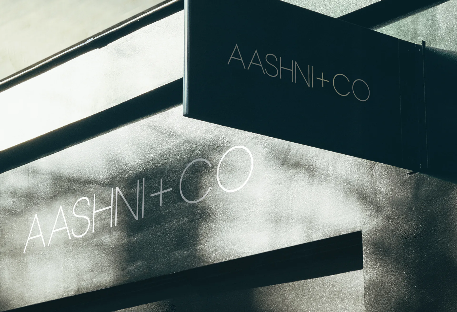 The AASHNI+CO name in white on a boutique window, and again on a dark fascia above.