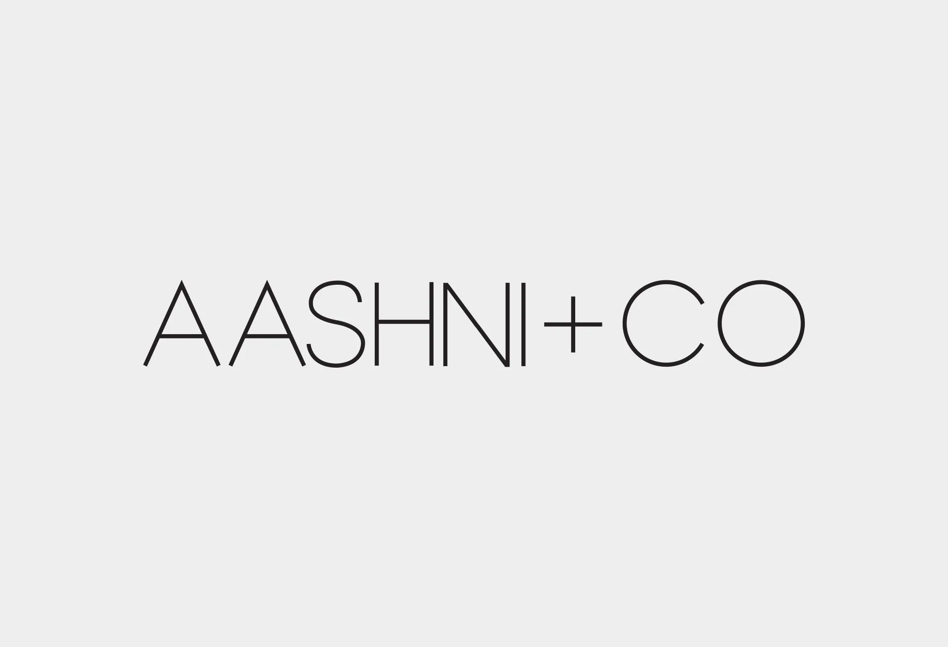 The AASHNI+CO logotype set in fine capitals on pale grey.