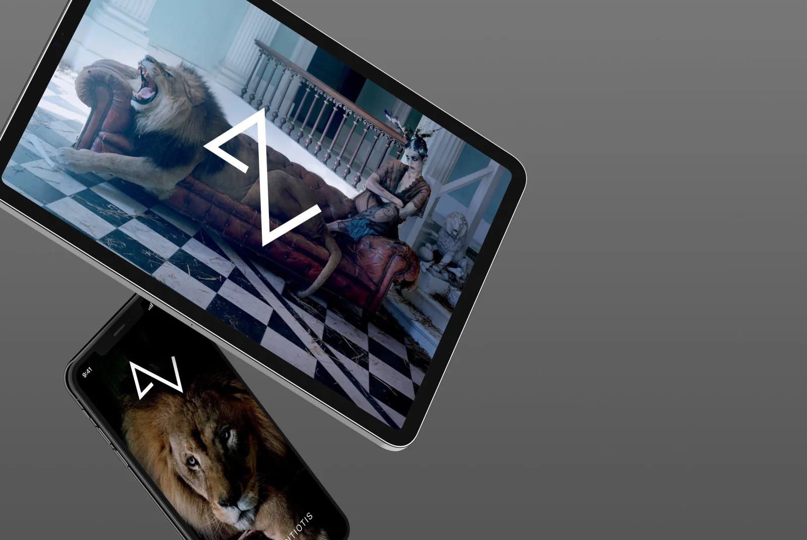 A tablet and a phone on grey, showing the A-Z site over a lion and an interior.