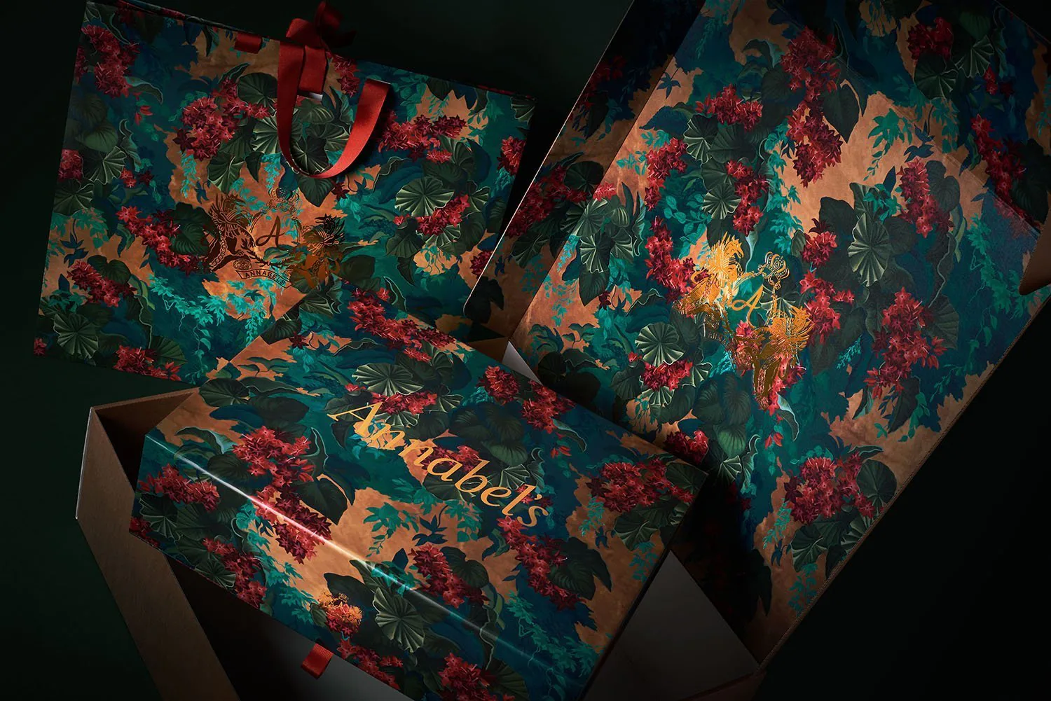 Annabel's boxes and printed sheets in teal, scattered with red and gold flowers.
