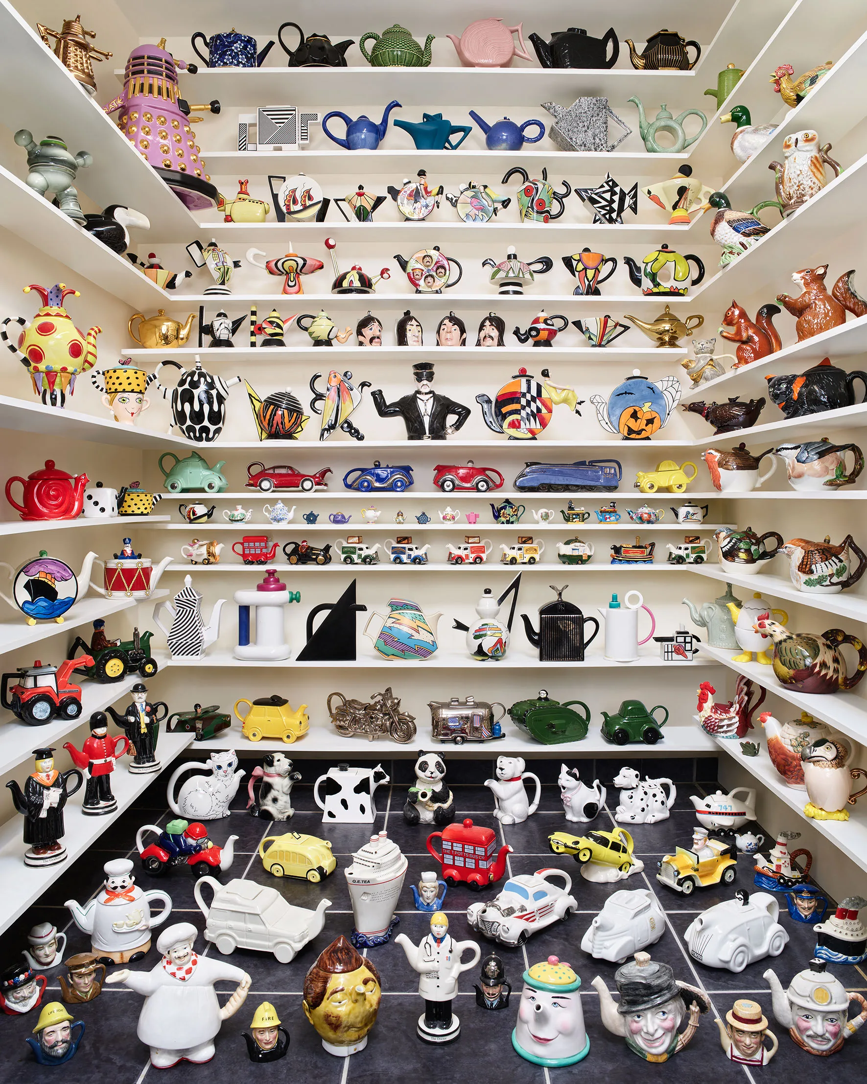 Part of a teapot collection, arranged on shelves.