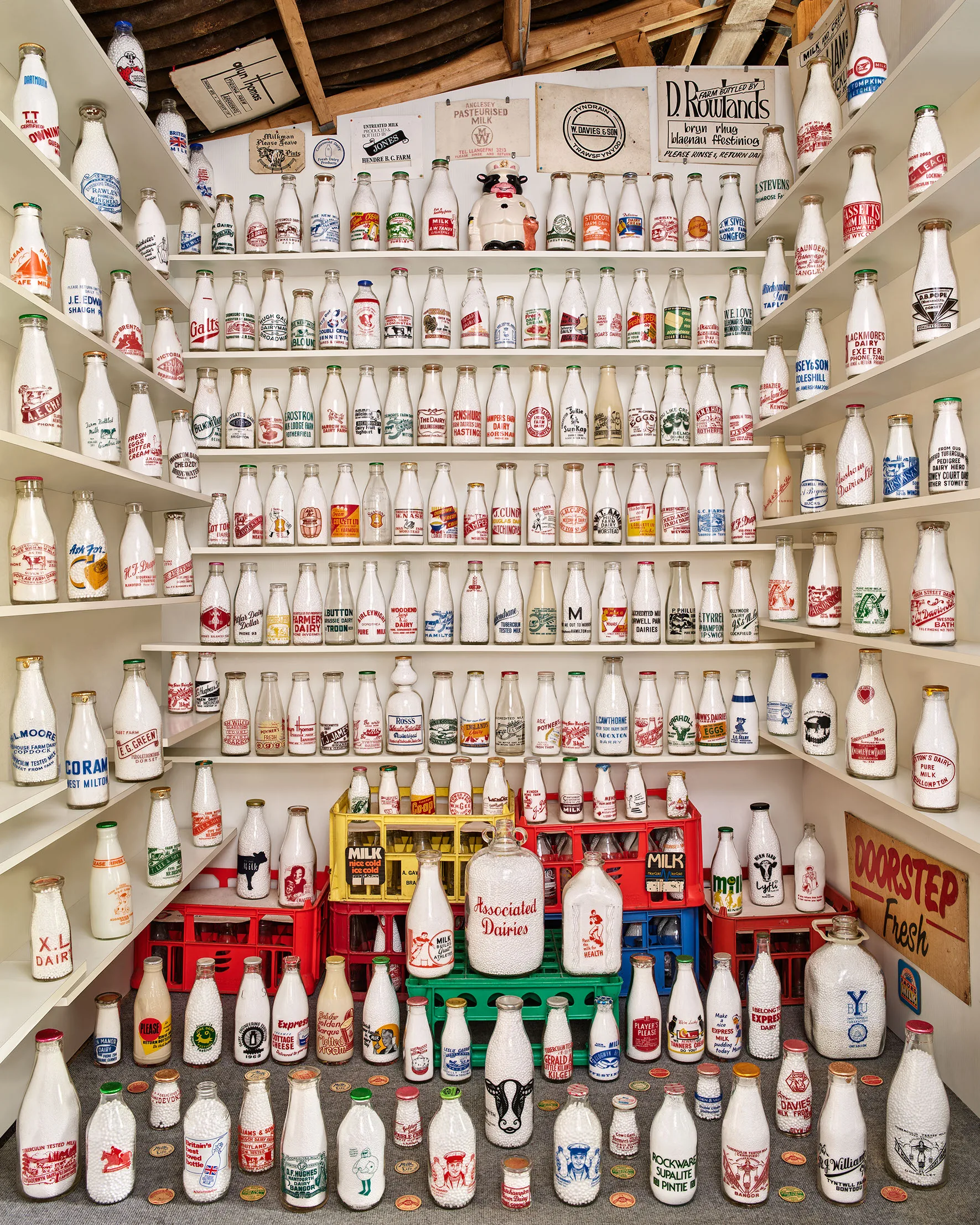 Part of a milk bottle collection, arranged on shelves.