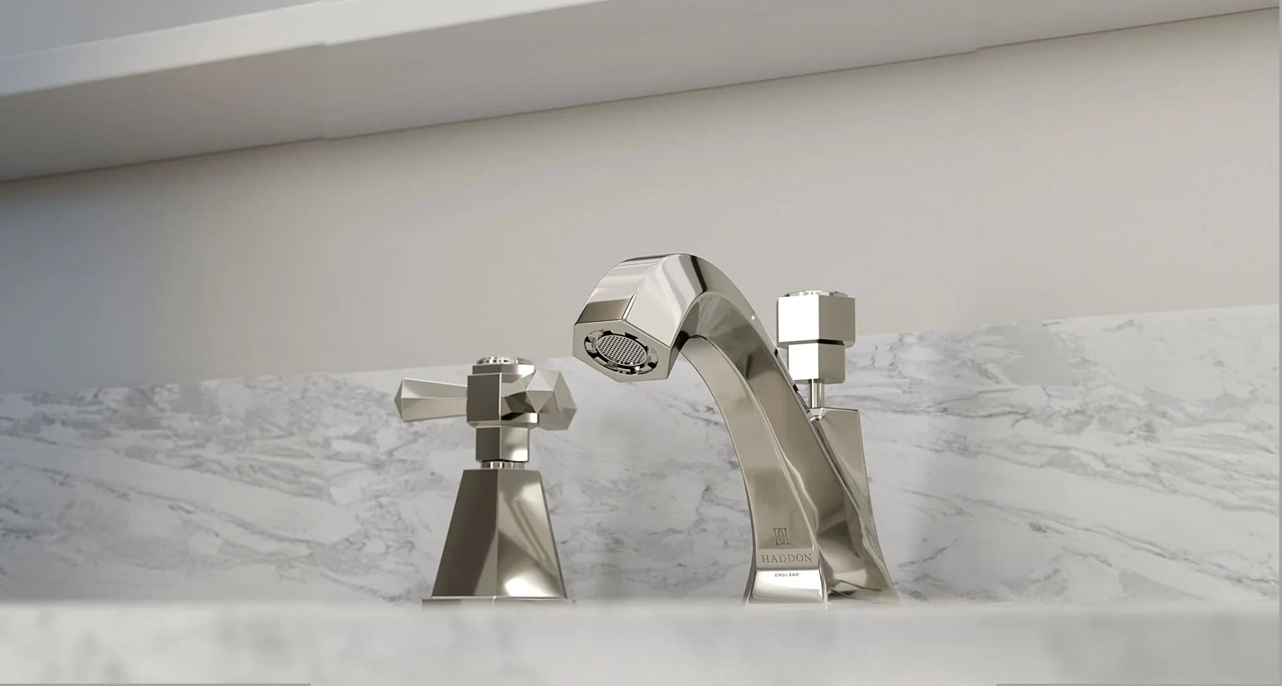 A nickel three-hole basin mixer with cross handles, set into a marble surface.