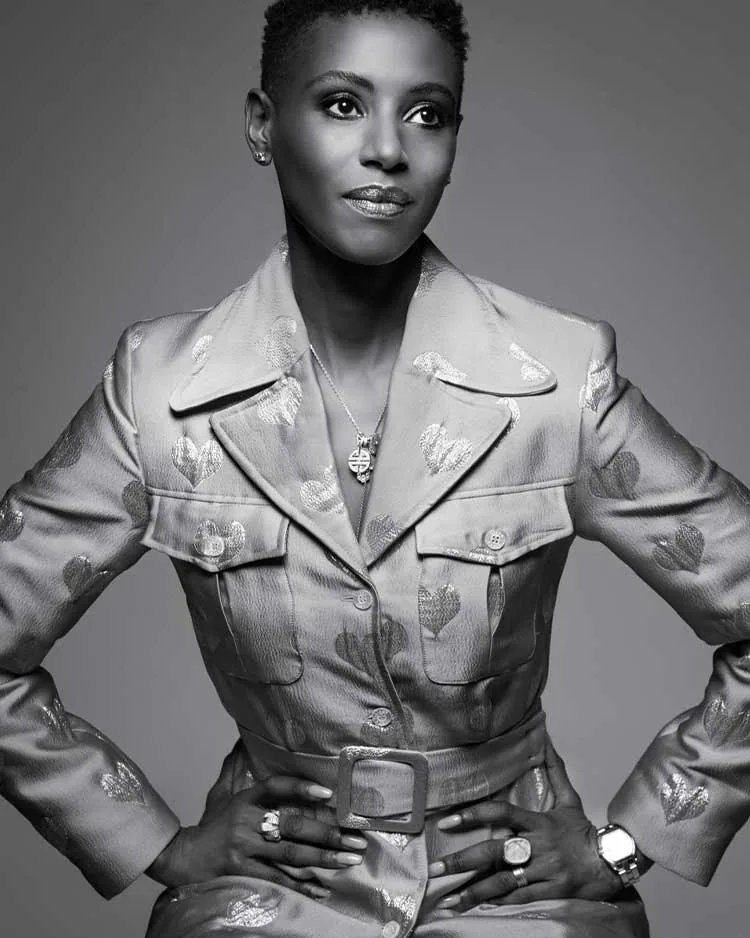 A close view of an embroidered jacket and a pendant, in black and white.