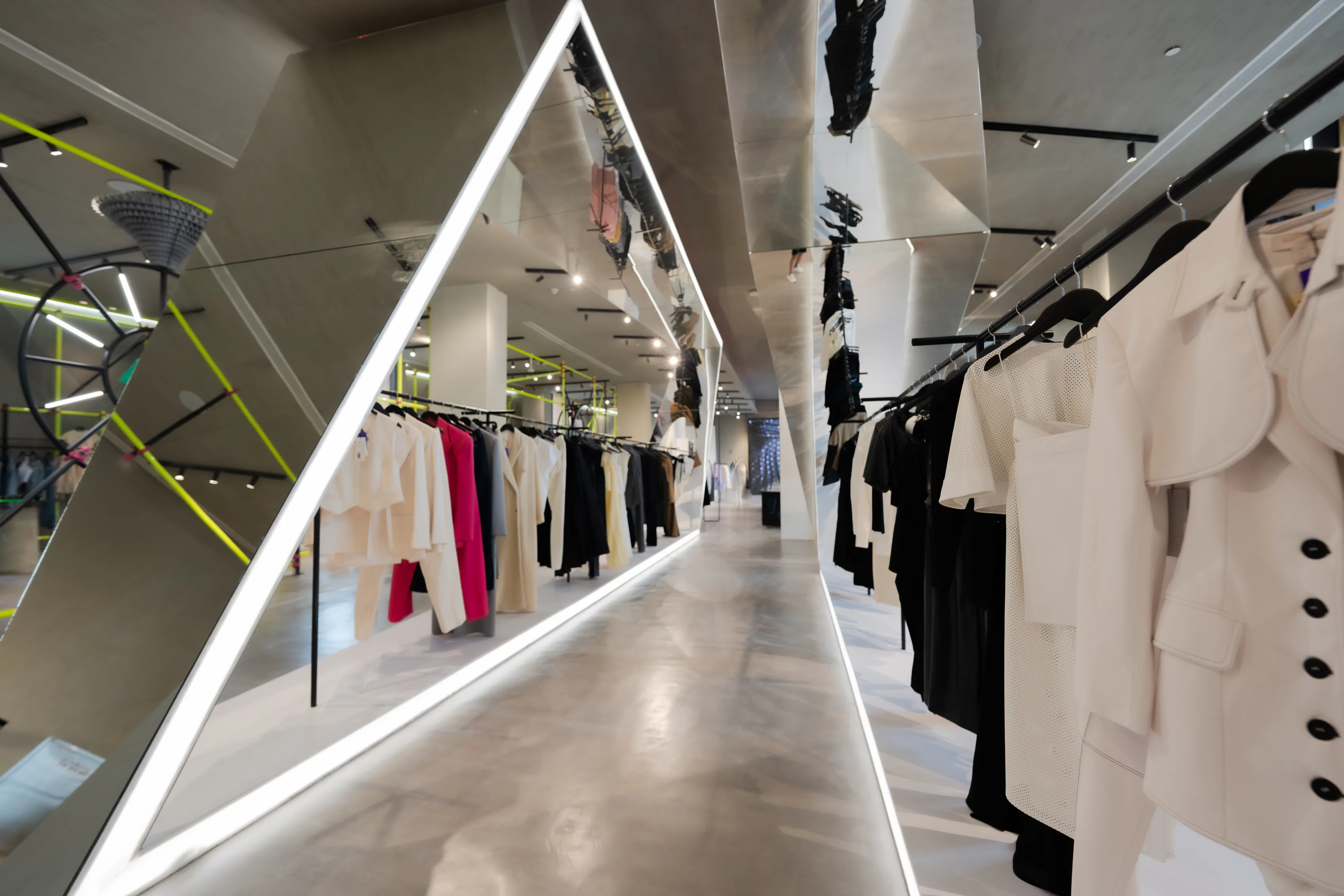 The MWAZ store interior, a lit corridor of rails under a mirrored ceiling.