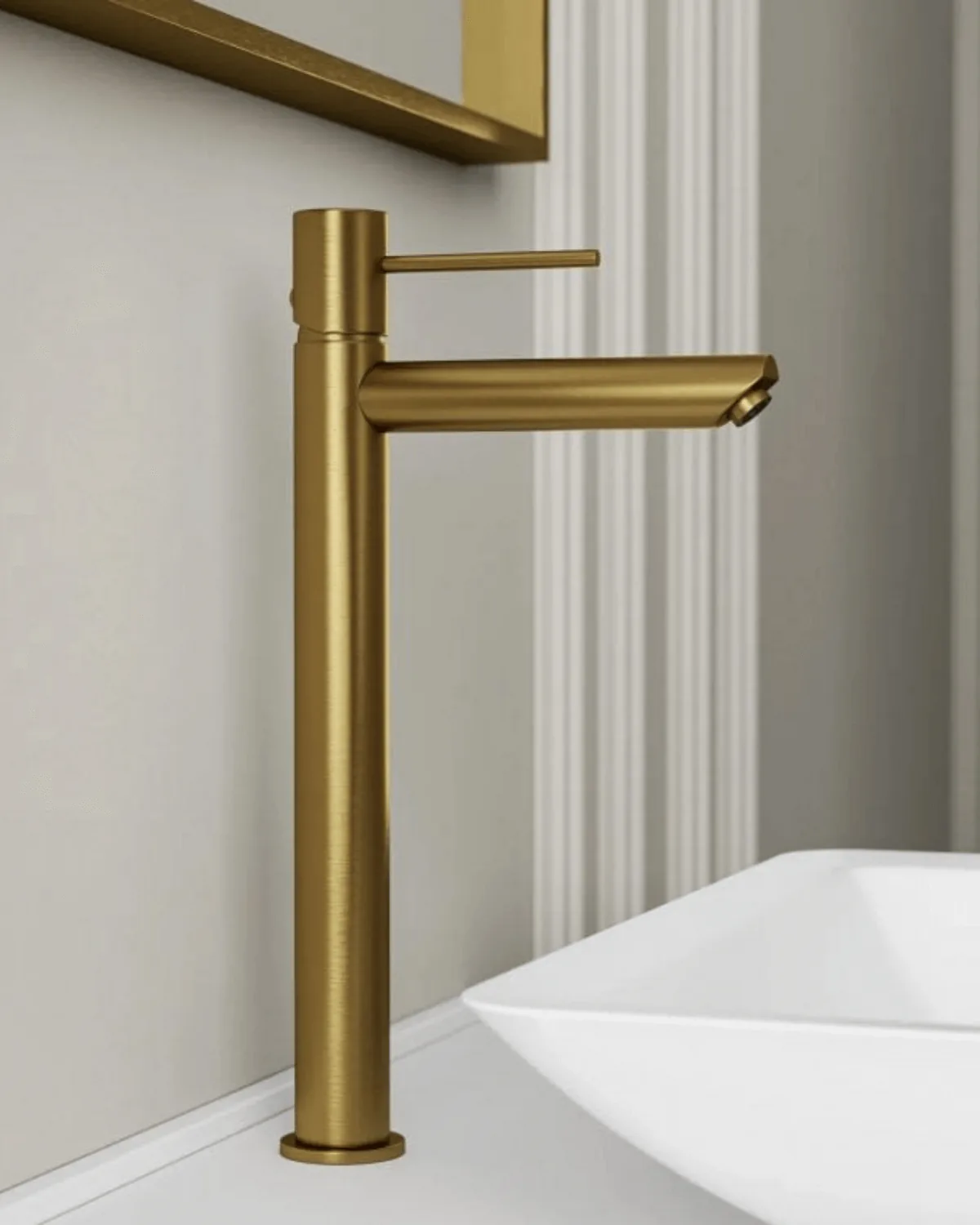 A tall brushed brass basin tap.