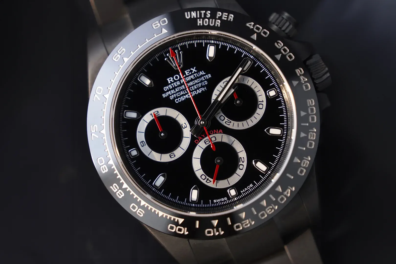 A blacked-out Rolex Daytona, close on the dial and its three subdials.