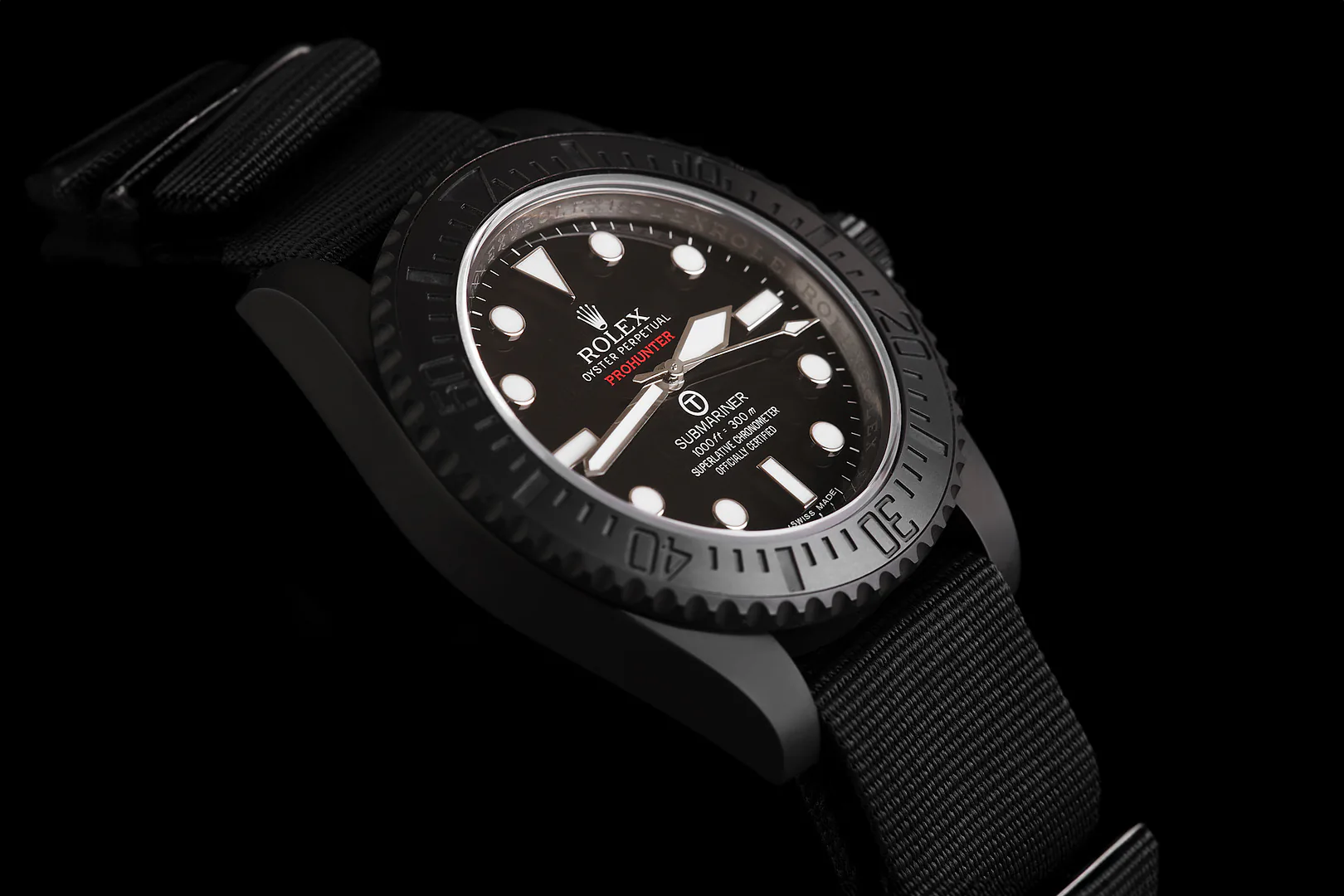 A blacked-out Rolex Submariner on a woven strap, seen at an angle.