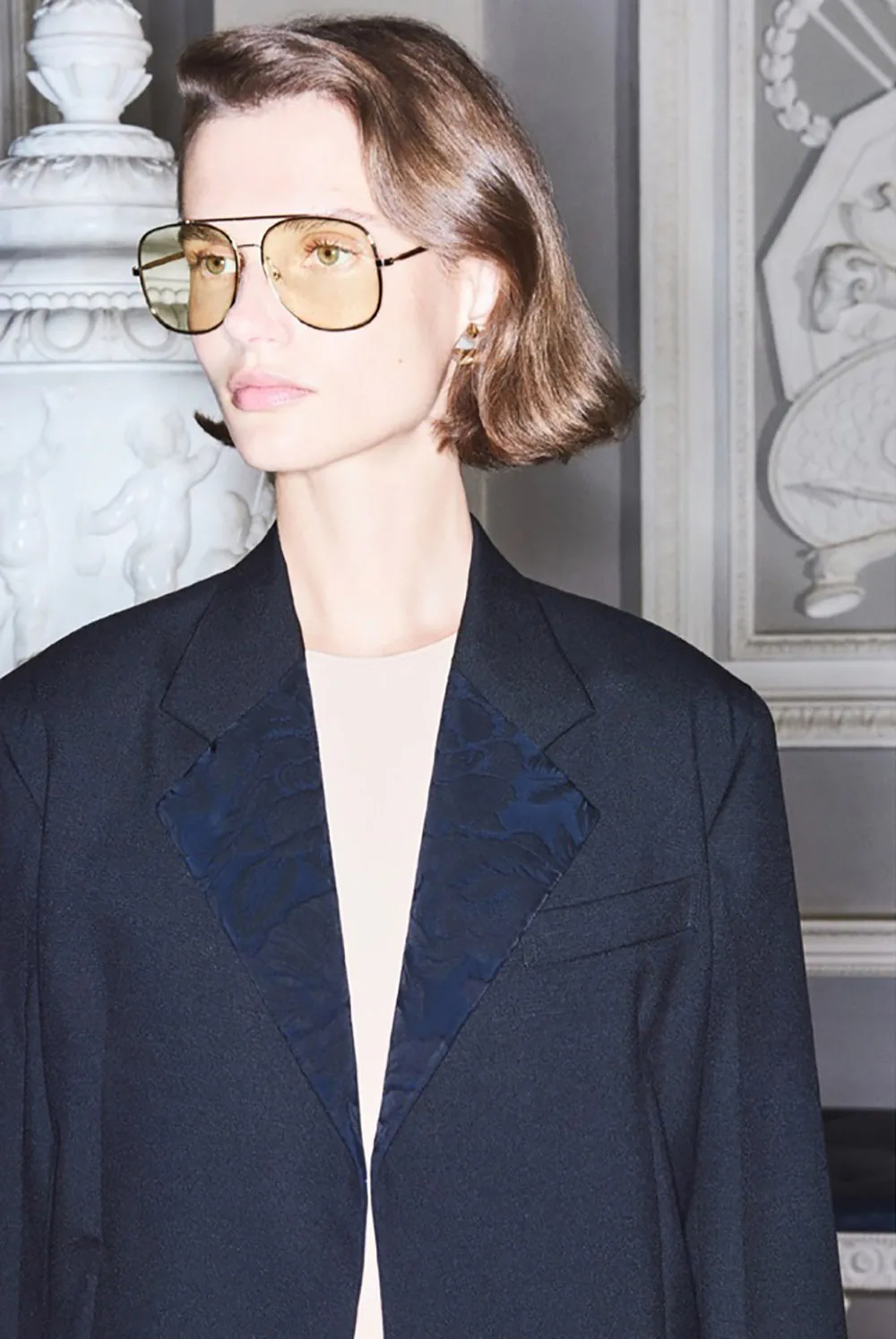 A model wearing Victoria Beckham eyewear and a tailored blazer.