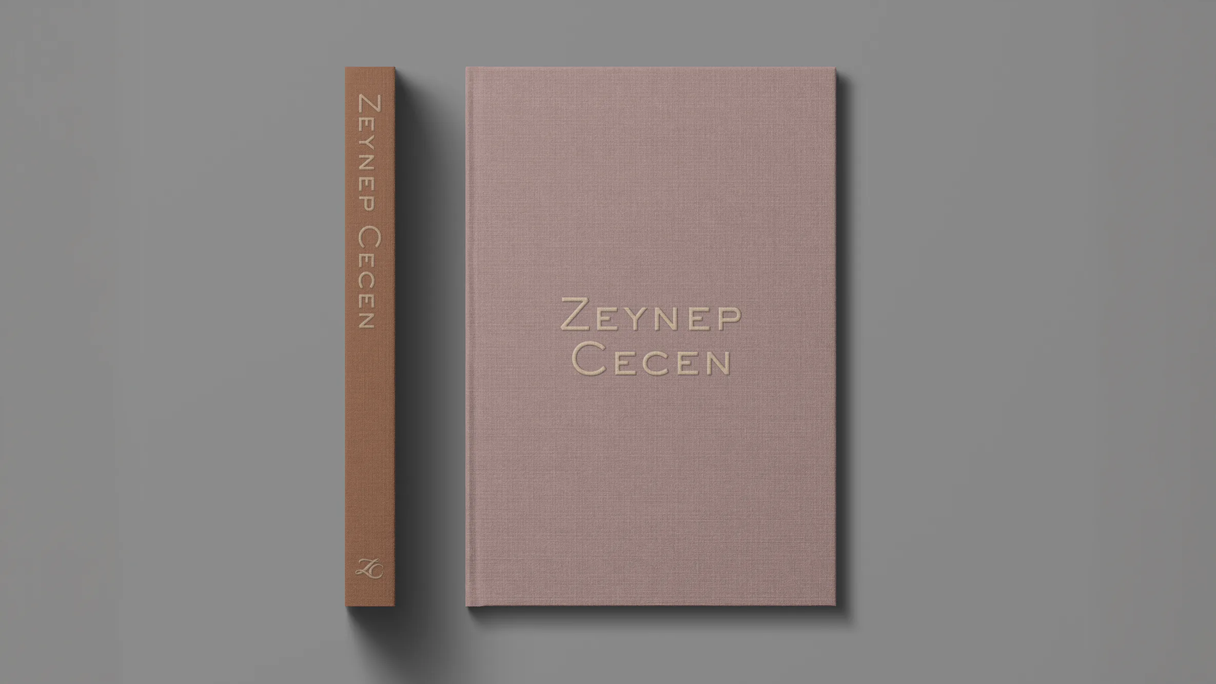Two bound volumes, one in dusky linen and one with a copper spine reading Zeynep Cecen.